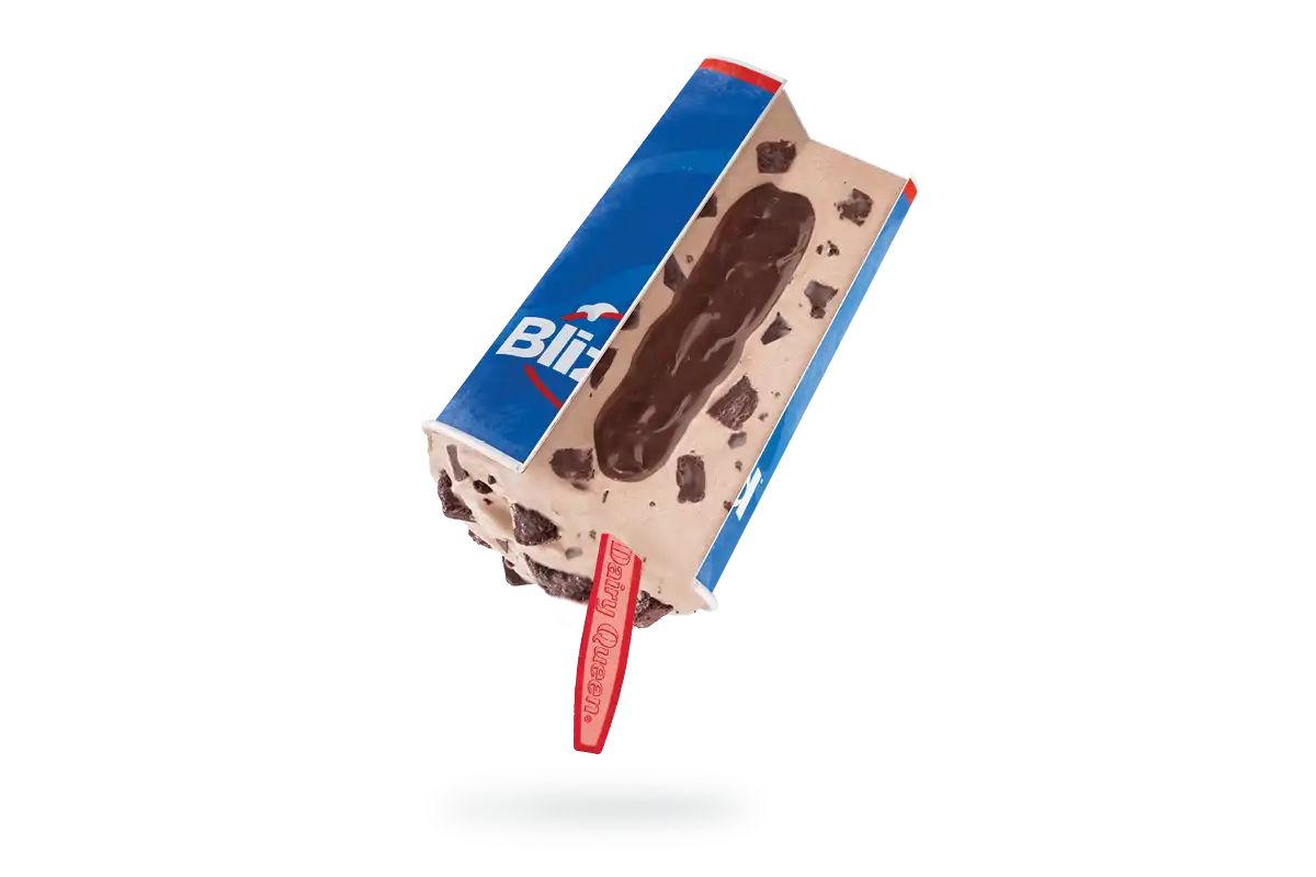 Upside down Royal Ultimate Choco Brownie Blizzard with a red spoon is cut open to show the fudge-filled core.